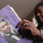 Jackie Chrisopher with a scrapbook documenting her son’s death in a police shooting